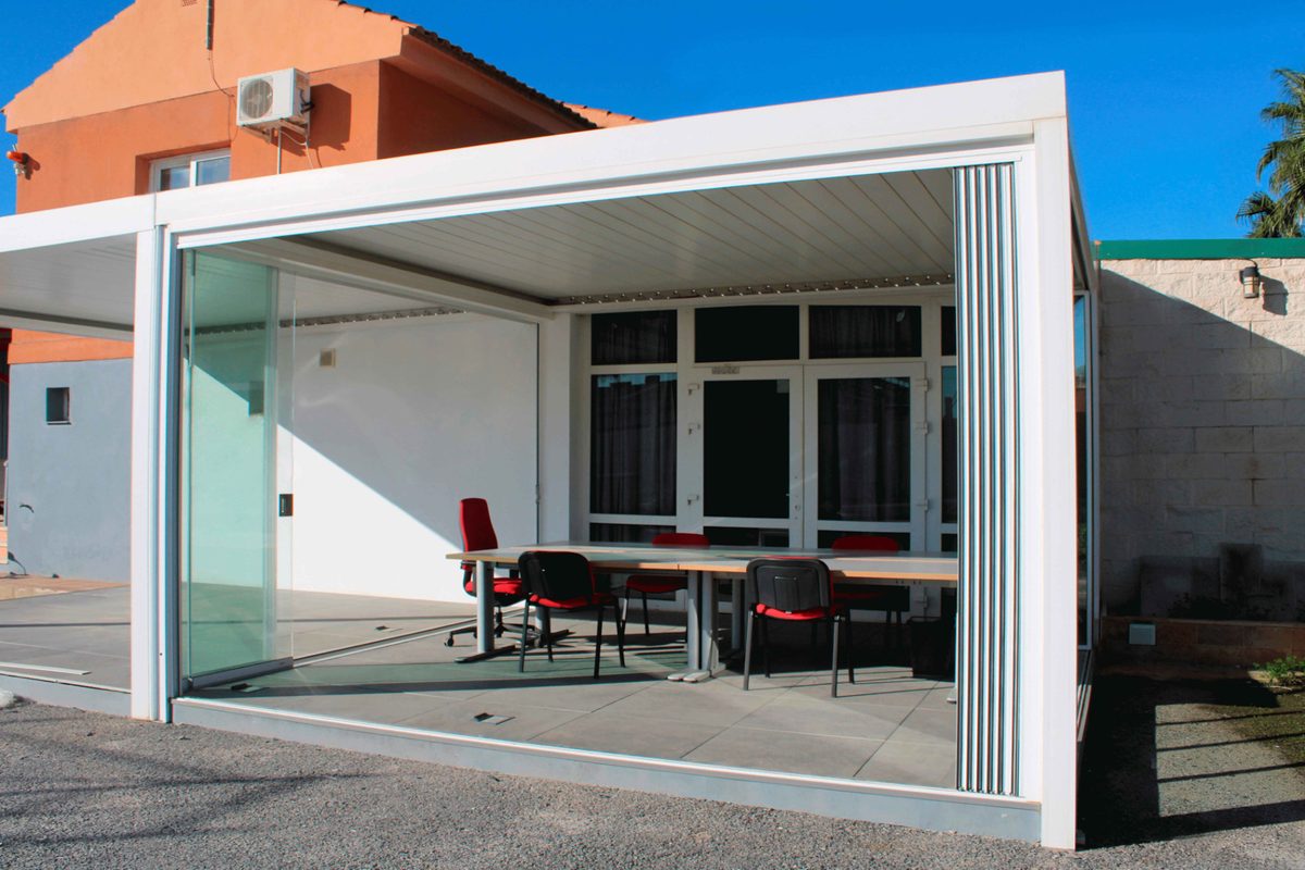 Office space before and after a frameless sliding glass enclosure — After