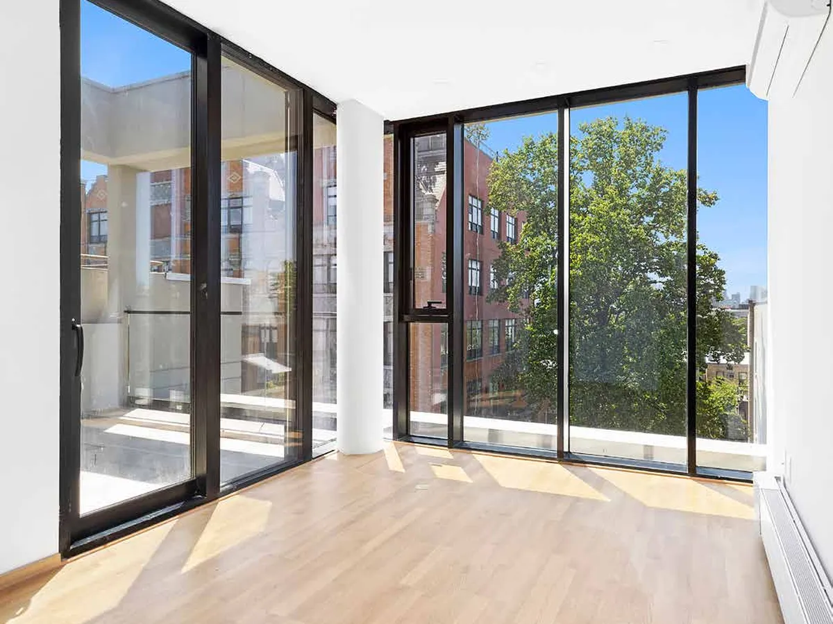 Interior corner glazed with very slim-sightline sliding panels running full height to a floor track.