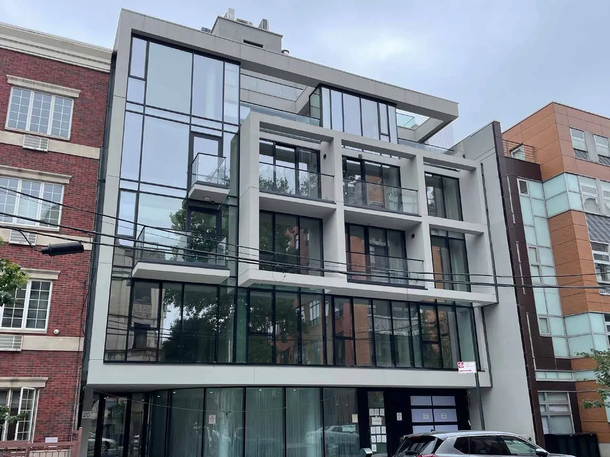 Street view of a mid-rise residential building whose glazing repeats floor by floor between projecting slab bands.